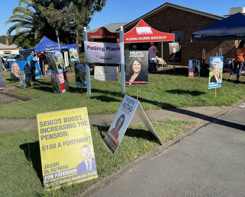 CONTEST: Campaign posters outside the Kurri Kurri early voting centre.