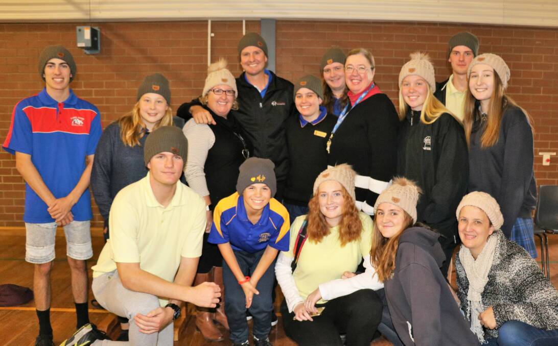 RUGGED UP: Mark Hughes with Kurri Kurri High School students and staff after the footy legend's talk at the school on June 5. Picture: supplied