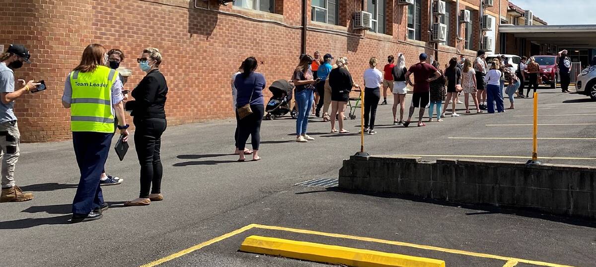 IN DEMAND: About 100 people in the queue for the Pfizer jab at Cessnock Hospital on Friday. Picture: Clayton Barr