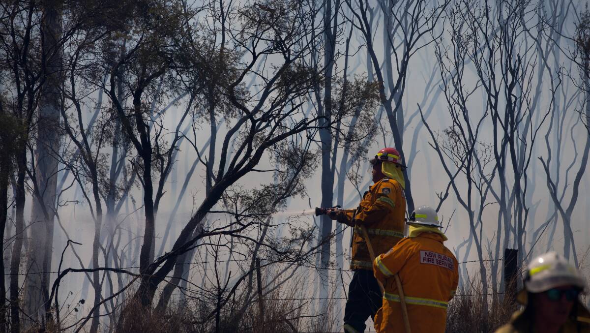 BRAVE: Firefighters work to contain a bushfire at North Rothbury last Tuesday, when a catastrophic fire danger warning was issued in the Greater Hunter. Picture: Marina Neil
