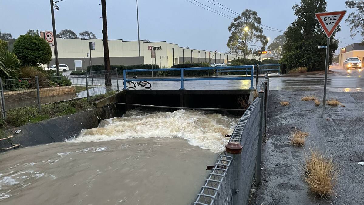 TORRENT: Storm water rushes through a drain in Charlton Street, Cessnock around 5pm Tuesday. Picture: Krystal Sellars