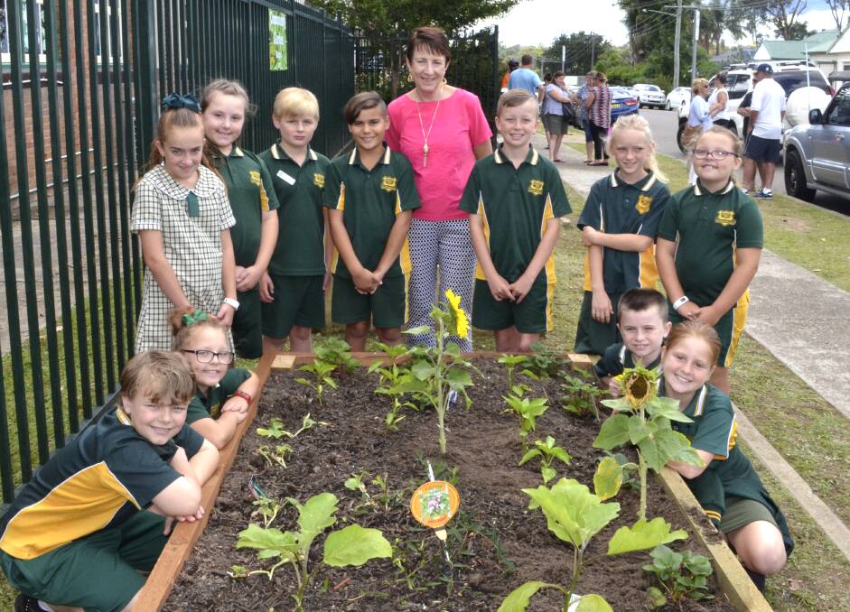 GREEN THUMBS: Cessnock West Public School stage two students and principal Ruth McGlashan at the newly-opened community garden. Picture: Krystal Sellars