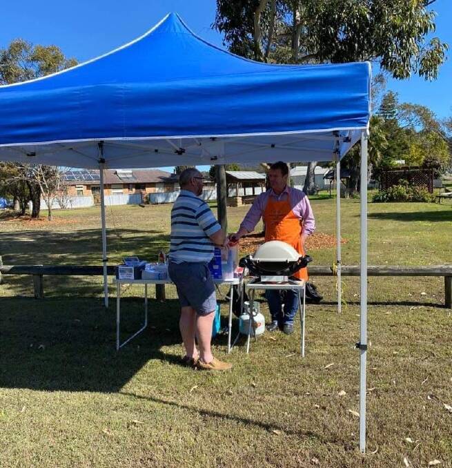 Clayton Barr and a resident at a recent 'Barr-BQ' at Bellbird. Picture supplied