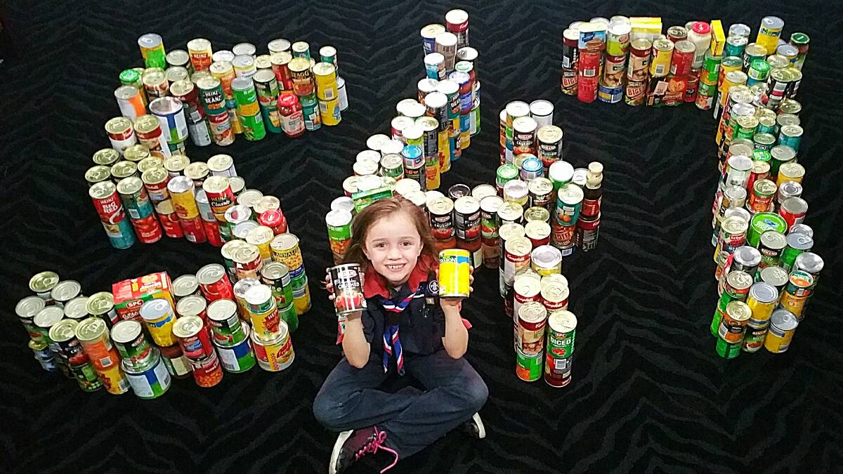 OVERWHELMED: Katie Martin collected 547 cans for Foodbank as part of a Joey Scouts challenge.