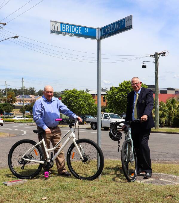 LINK: Council's traffic and transport infrastructure principal engineer Warren Jeffrey and Cessnock mayor Bob Pynsent on the future path's route on Cumberland Street. Bikes supplied by Cessnock Bicycle Company.