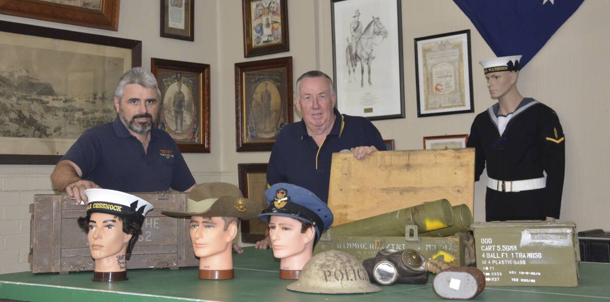 FASCINATING: Open day organisers Tony Sheehan and Greg Ingle with some of the memorabilia that will be on display at Cessnock RSL Hall on June 25.