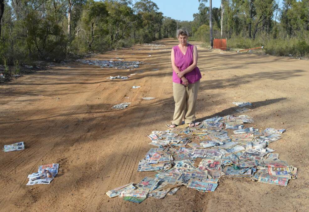 MESS: Racecourse Road resident Sheryl Stuckings with some of the catalogues that were recently dumped on her road. Picture: Krystal Sellars
