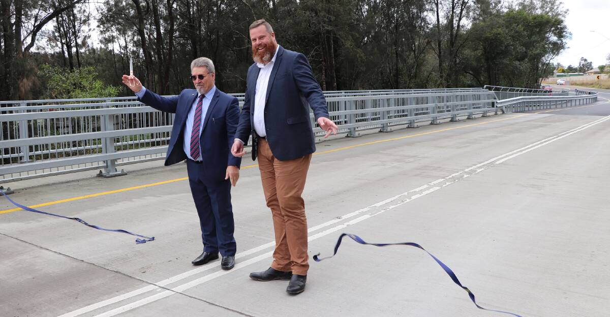 OPEN: Cessnock deputy mayor John Moores and Member for Hunter Dan Repacholi cut the ribbon to declare the new Anvil Creek Bridge open.