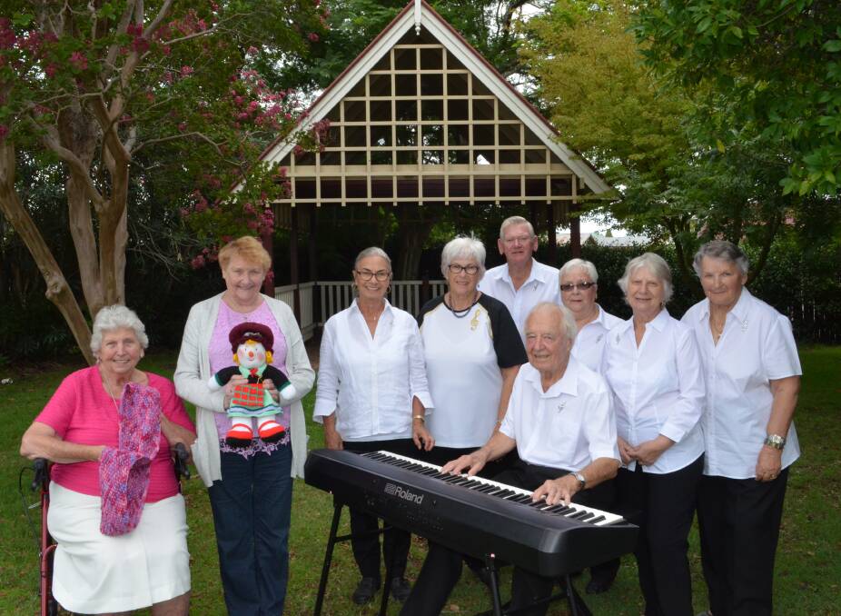 GARDEN GATHERING: Shirley White and Phyllis Locock, from Marthaville Arts and Cultural Centre, with Cessnock Seniors Choir members Mina Van Bree, Noelene Skinner, Geoff Thomson, Michael Griggs (seated), Eileen Allison, Carolyn Grimshaw and Laurel Hopkins, ready for the performance and open day.