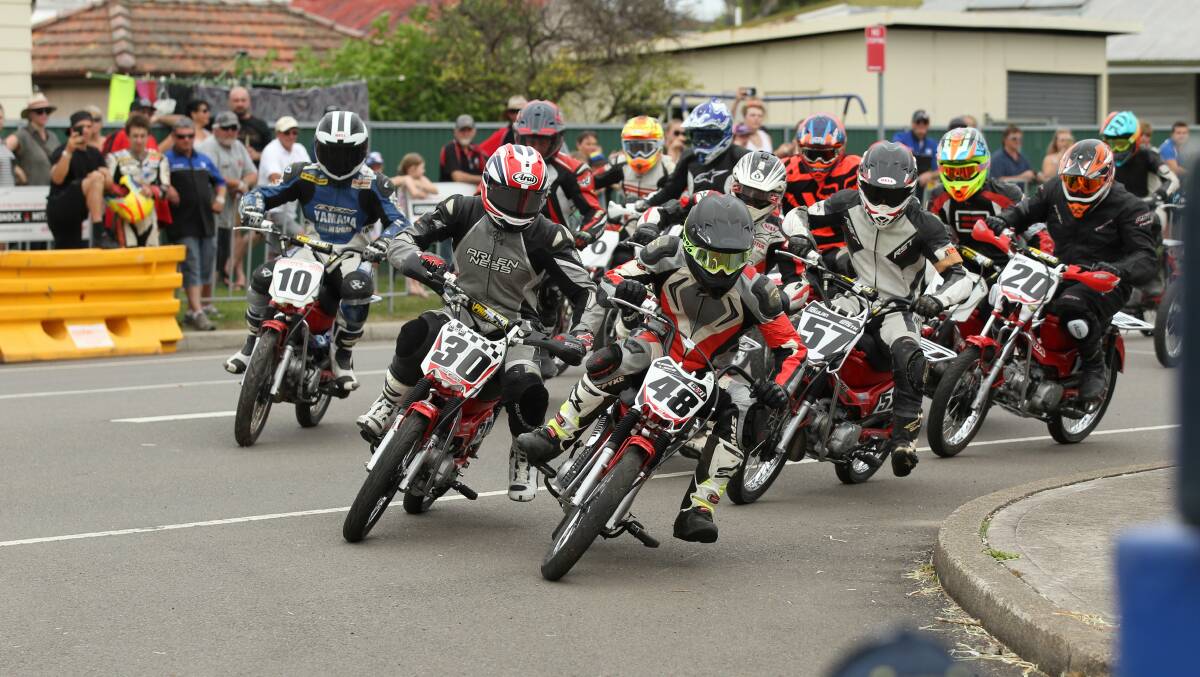 TEAR IT UP: Riders lean into a corner at high speed at the Postie Bike Grand Prix in Cessnock on October 30. Picture: Max Mason-Hubers
