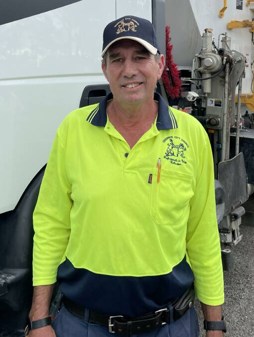 PROUD: Alan Bailey wearing the waste team's old uniform, a specially-designed shirt featuring a goanna and a bulldog.