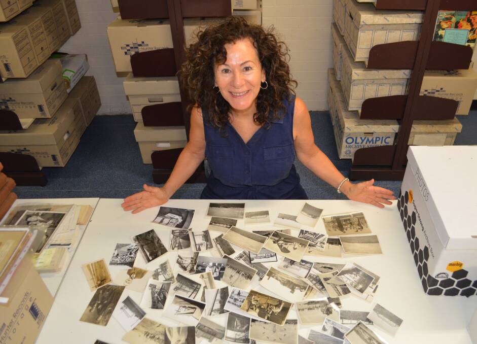 FASCINATING: Cessnock Library's local studies librarian, Kimberly O'Sullivan, with some of the photos from the library's extensive collection. Picture: Krystal Sellars