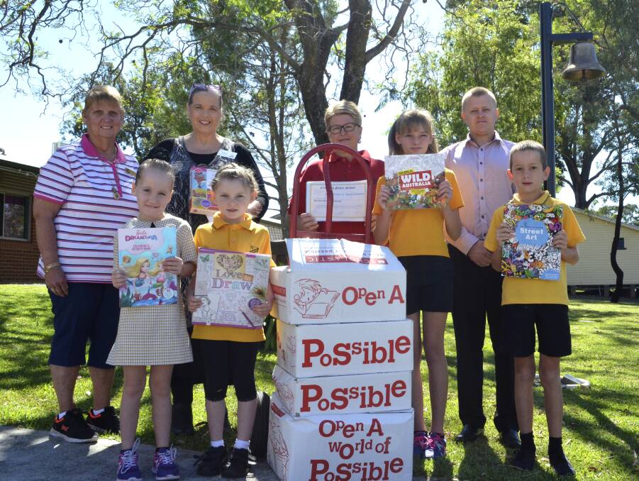 KIND DONATION: Pictured at back, Cessnock Public School teachers' aide Gail Tsakissiris, John Hunter Children’s Hospital child life therapist Veronica Oakley, Bunnings Warehouse Cessnock activities organiser Sue Whitaker and school principal Steve Morgan, and at front, students Abbie, Jorja, Georgia and Kyle with some of the books that the school donated to the hospital. 
