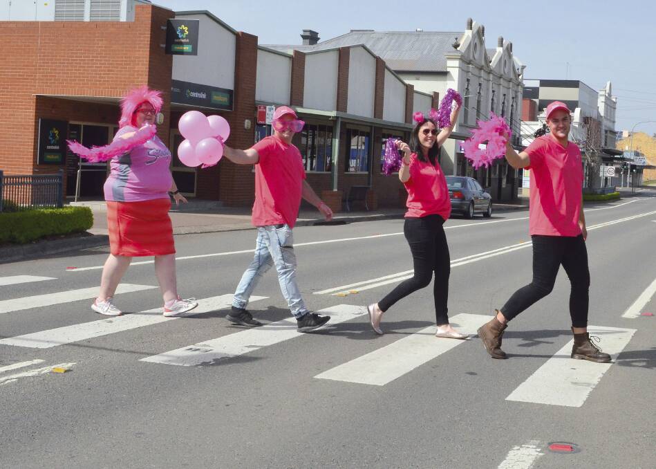 LET'S GO PINK: Cessnock Pink Up Your Town committee members Stacy Jacobs, Adam Robinson, Laura Andrew and Shane Wilson 'pinking up' Vincent Street. 
