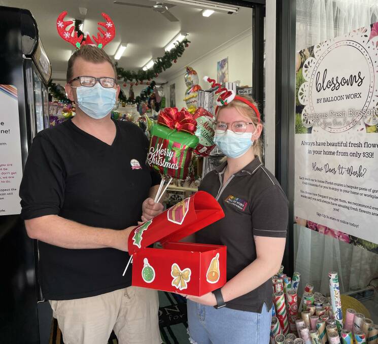 DROP-OFF POINT: Balloon Worx staff Clint Ekert and Lilly Parsons with Santa's mailbox. The Advertiser will publish our 38th annual Letters to Santa feature on December 15.