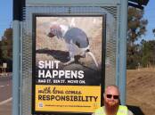 Sending a Message: Council ranger Nathan Cook with a bus-shelter poster for a new campaign about responsible pet ownership.    