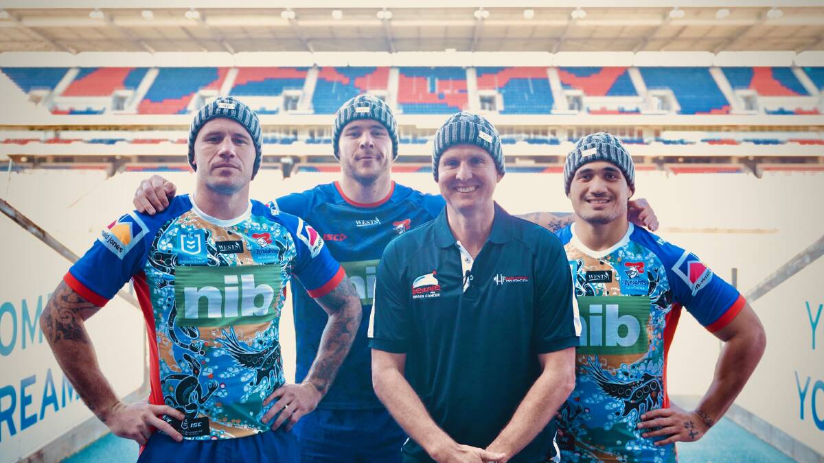 BEANIES: Knights players Shaun Kenny-Dowell, David Klemmer and Sione Mata'utia with Mark Hughes.