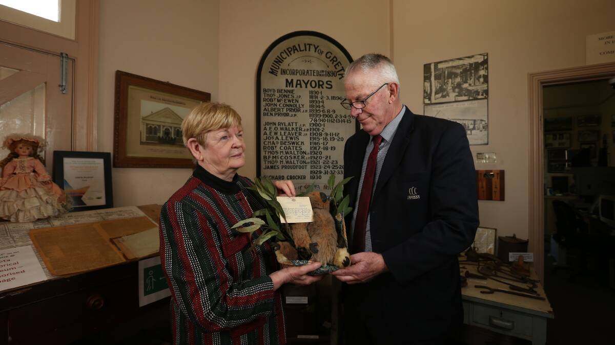 HISTORY: Maira Kluina hands the toy koala to Cessnock Mayor Bob Pynsent for Greta Museum to display. Picture: Simone De Peak