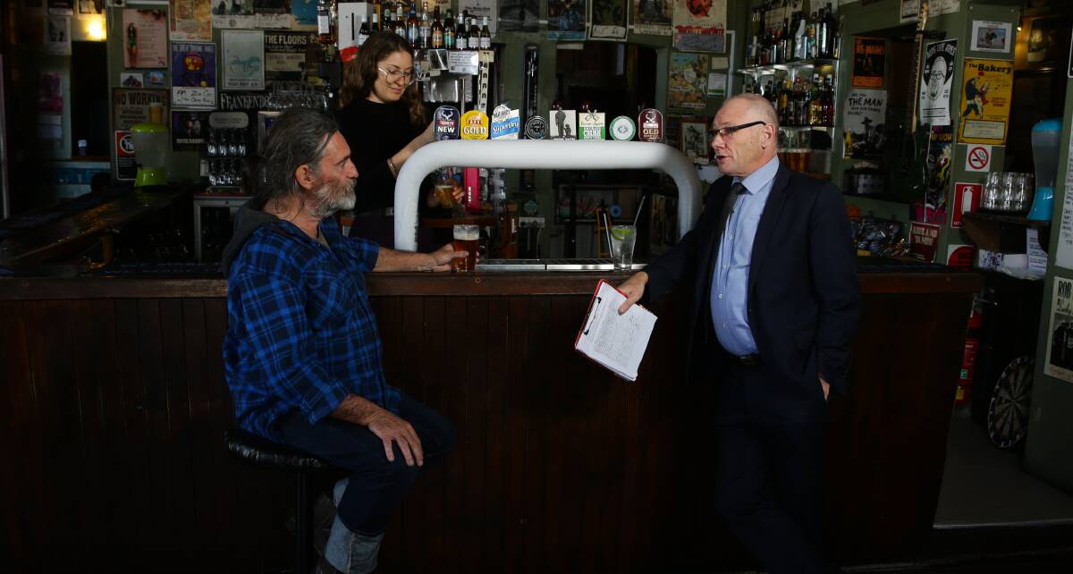PUB CHAT: Pastor Bob Cotton discusses his petition for stronger penalties for concealing child sex abuse with patron Garry Broad at the Grand Junction Hotel. Picture: Jonathan Carroll