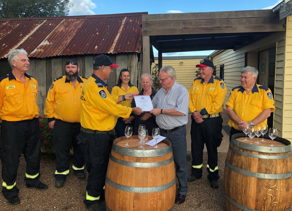 JOB WELL DONE: Captain Stephen Drayton of Pokolbin RFS gives Bruce Tyrrell a certificate of appreciation for his $5000 donation.