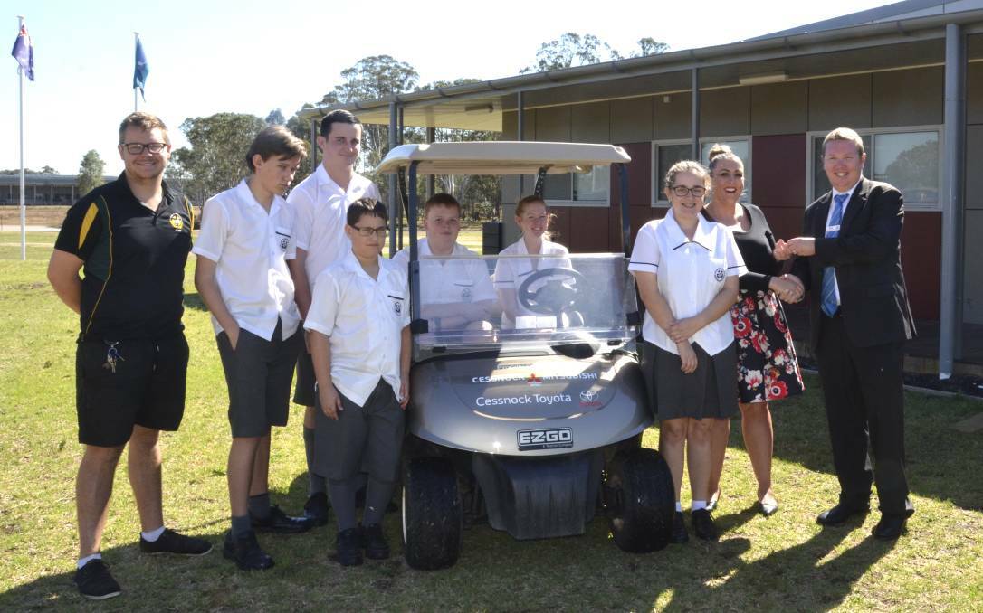COMMUNITY SUPPORT: DALE Christian School Cessnock students and staff with Cessnock Mitsubishi general manager Scott Harris and the donated golf cart in 2017.
