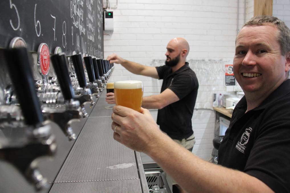 Bottoms up: Tumut River Brewery owners Tim Martin and Simon Rossatat officially opened their renovated brew house last year. 