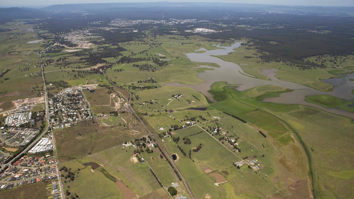 MASSIVE POTENTIAL: An aerial view of part of the Kurri smelter site looking south-west to the smelter with environmental wetlands to the right, and land to be developed for housing between Gillieston Heights in the foreground, and Cliftleigh, closer to the smelter.
