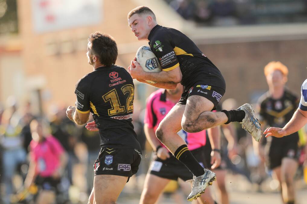 Cessnock fullback Harry O'Brien flies in the air to catch the ball safely on his chest. Picture by Max Mason-Hubers.