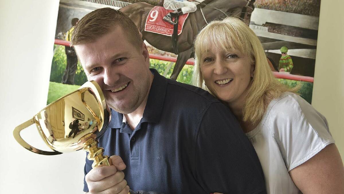 SPRING CARNIVAL: Luke Murrell and wife Sharyn with the Melbourne Cup in 2014. Picture: Cath Bowen