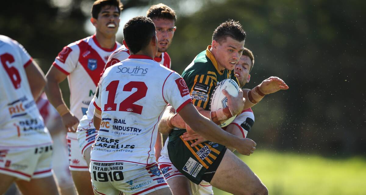 WRAPPED UP: Macquarie's Kerrod Holland runs into Souths defenders at Townson Oval on Saturday. The Scorpions won 22-10. Picture: Marina Neil