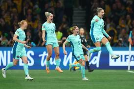 Matildas stand-in skipper Steph Catley, right, celebrates her goal to seal Australia's win over Canada in Melbourne on Monday night. Picture by Getty Images