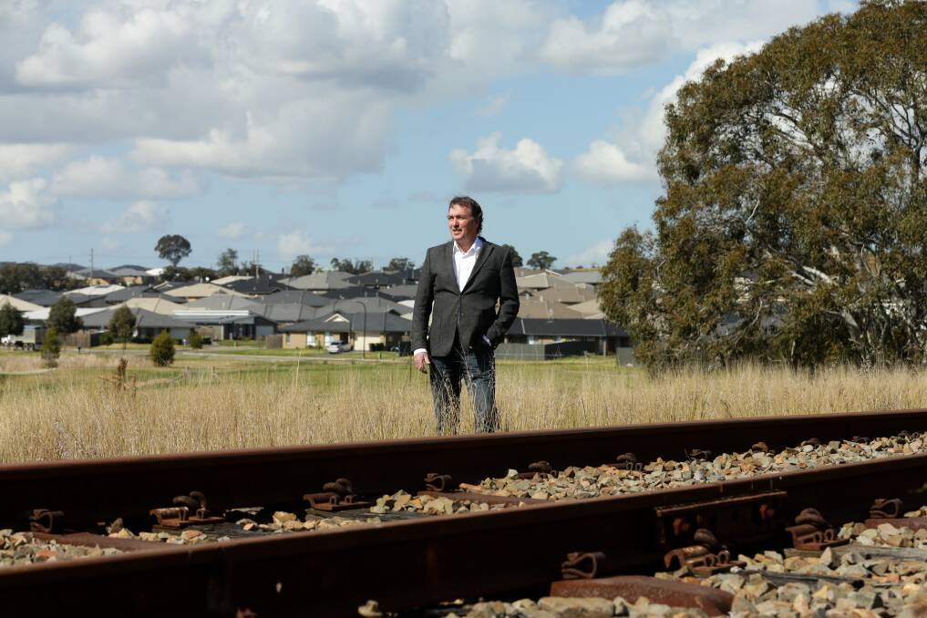 COMMUTER PROXIMITY: Geoffrey Rock, the Urban Development Institute of Australia's Hunter chapter chair, alongside the rail line adjacent to new housing in Gillieston Heights. Picture: Jonathan Carroll 