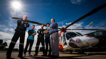 PARTNERSHIP: Westpac Rescue Helicopter air-crew officer Glen Ramplin, with driver Michael Caruso, pilot Andre Smith, driver Cameron Waters and Westpac Rescue Helicopter Service CEO Richard Jones. Picture: Simon McCarthy.