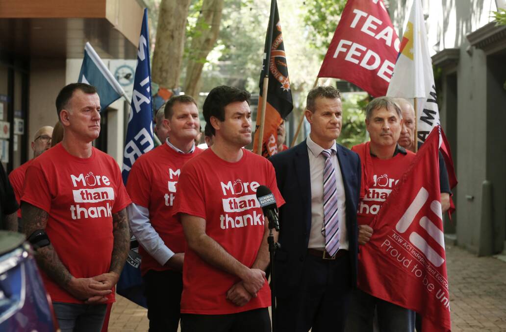 Teachers federation members, pictured with Newcastle MP Tim Crakanthorp here in December 2021, have long called out a shortage of teaching staff across the state. Picture by Simone De Peak
