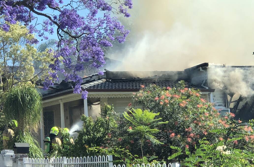 DAMAGE CONTROL: Firefighters were forced to fight the blaze from outside after a house's roof collapsed. Picture: Courtesy of Fire and Rescue NSW.