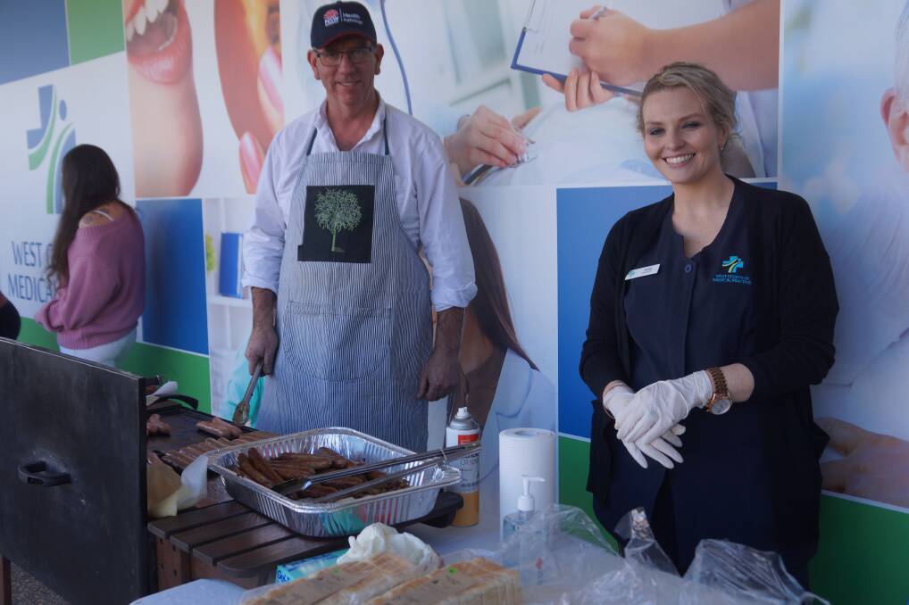 Sausage Sizzle: Cam Sparrow and Jacqi Bell fed the hungry crowd at the recent 1st Birthday celebrations for West Cessnock Medical Practice. Photo: Jye Metcalfe.