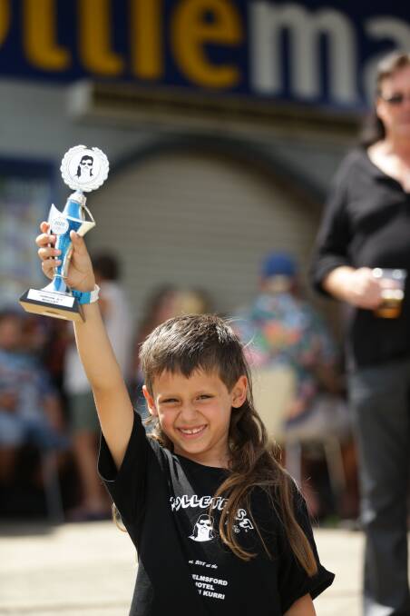 Western Australian Dean Singh shows of his trophy after winning the 4-7 year-old junior mullet award at Mulletfest 2020 on Saturday. Picture: Jonathan Carroll 
