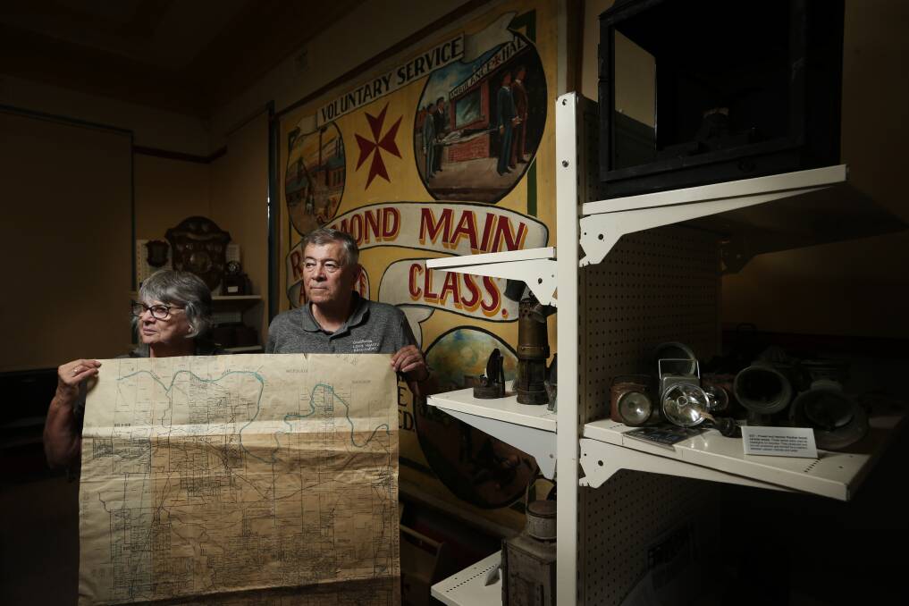 MAPPING MEMORIES: Lexie Matthews and Bill Holland at the Coalfields Local History Association's museum in Abermain.