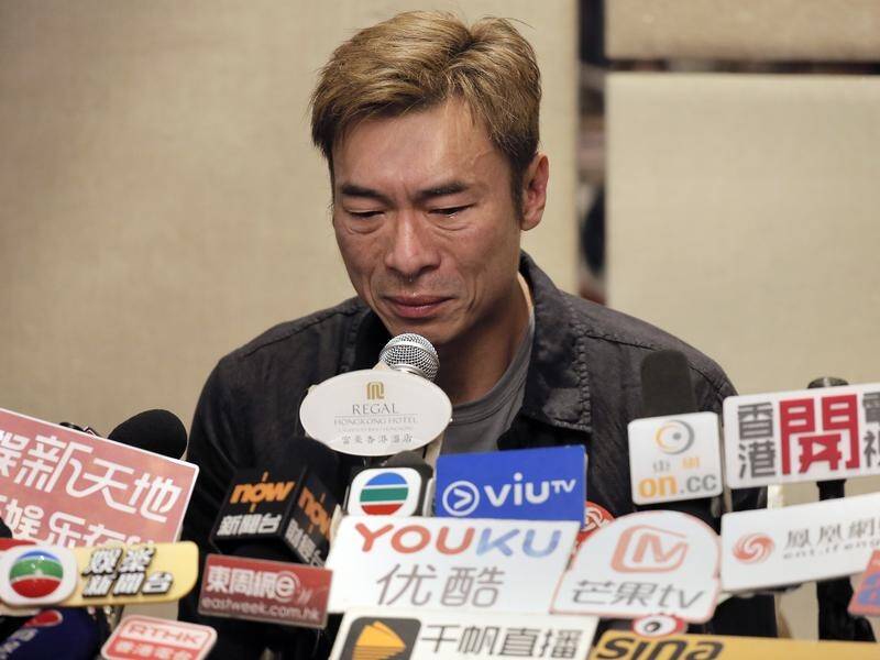 Hong Kong singer Andy Hui reacts during a press conference about his affair with an actress.