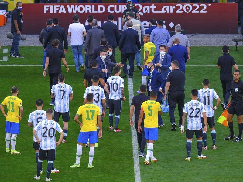 Lionel Messi (10) talks to health officials after they interrupted the Brazil-Argentina qualifier. (AP PHOTO)