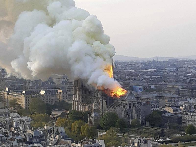 Flames and smoke rise from the blaze at Notre Dame cathedral in Paris.
