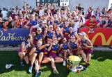 Brisbane Lions players celebrate winning the 2023 AFLW decider in Melbourne with fans. (Joel Carrett/AAP PHOTOS)
