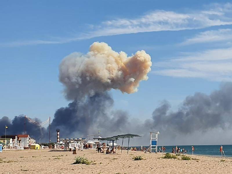 Smoke rises over the beach at Saky following blasts at the nearby Russian military air base. (AP PHOTO)