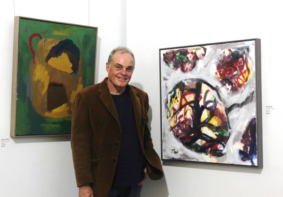 CIRCULAR: Artist James Whitington with two of the works that will be featured in his upcoming Retroactive exhibition at Cessnock Regional Art Gallery.