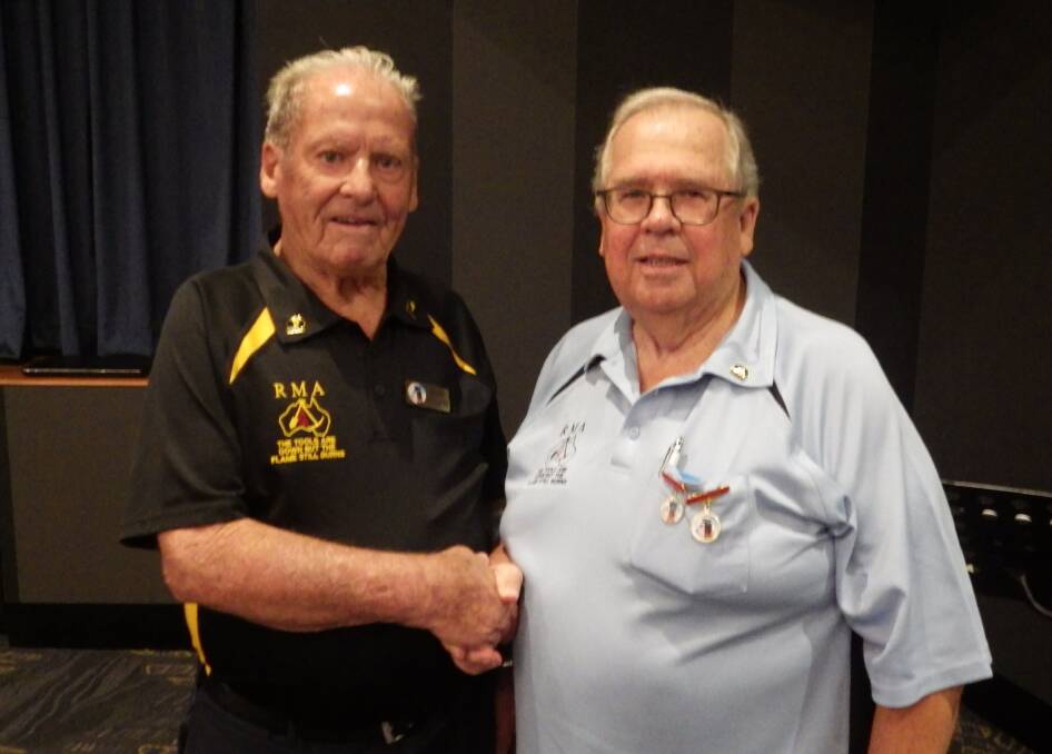 HONOUR: Cessnock Retired Mineworkers President, Brian Collett (left)
congratulates Laurie Ellis (right) on his life membership.