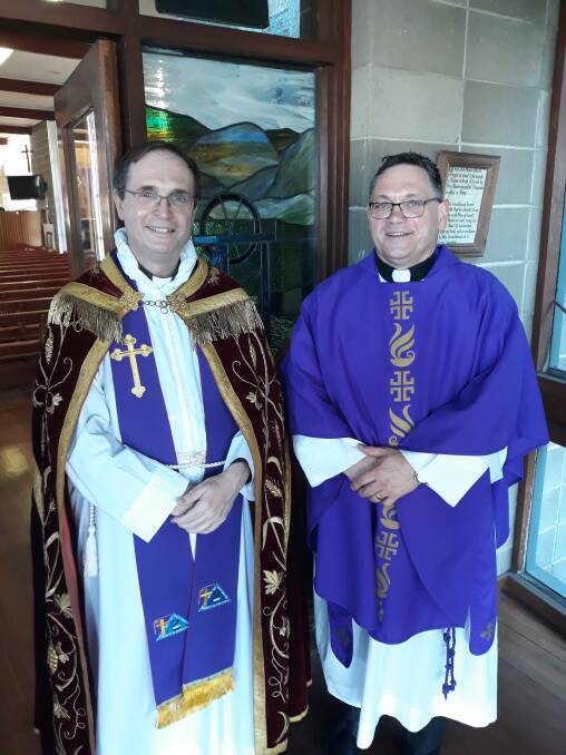 WELCOME BACK: Father Keith Joseph (left) at the first service conducted by Father John Quilter (right) in St Paul’s Church Kurri Kurri on Saturday.