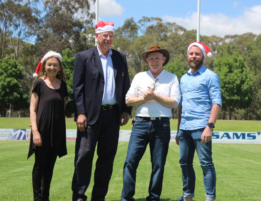 BIG VOICE: Staff from Cessnock Performing Arts Centre practicing their carols with Mayor Bob Pynsent at Cessnock Sportsground. Picture: Stephen Bisset