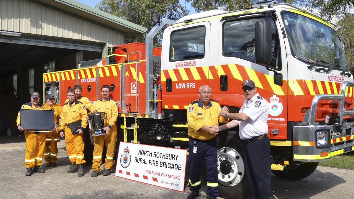 MUCH-NEEDED: From left, North Rothbury Rural Fire Brigade volunteer firefighters Owen Parker, Sonia Ivan, Darren Bendeich, Rodrick Fletcher and Stephen Fletcher with their new equipment and on the right, Lower Hunter inspector Ken Hepplewhite hands the keys for the new truck over to Lower Hunter group officer John Ryan (on behalf of North Rothbury captain David Seabrook).