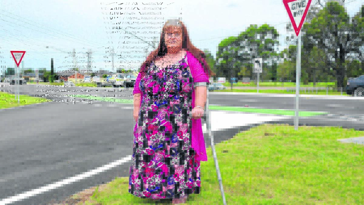 CONCERNED: Sharon McNaughton near the new median strip on Main Road, Heddon Greta. She says drivers are ignoring the no U-turn sign to get back onto the Hunter Expressway.
