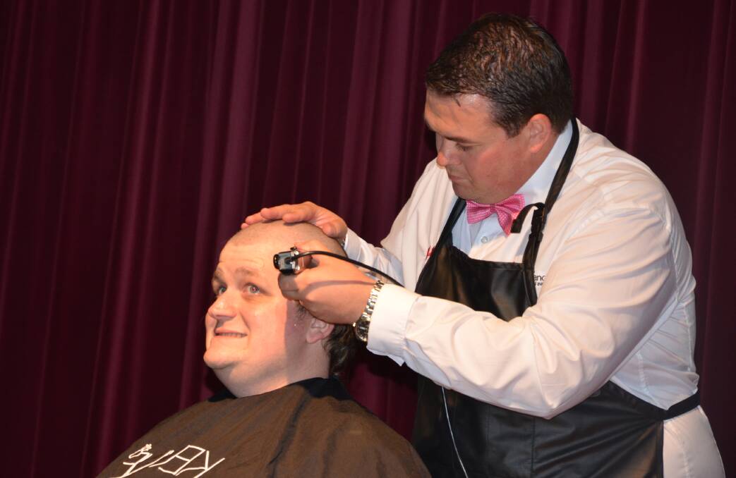 HAIR NO MORE: Anthony Burke takes the clippers to Clint Ekert’s hair at Dine 4 Charity.